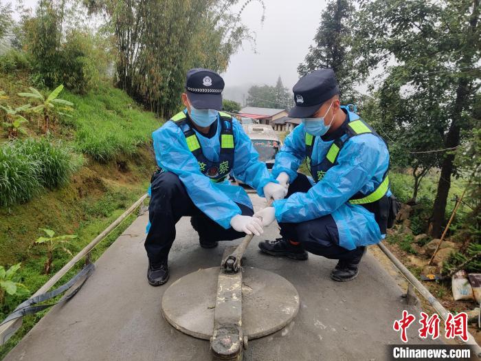 图为罗夸新和罗春新正在检查车辆。　普洱边境管理支队供图